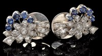 Lot 933 - A pair of sapphire and diamond stud earrings,...