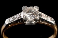 Lot 935 - A diamond ring, the central brilliant cut...