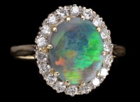 Lot 937 - A black opal and diamond cluster ring, the...