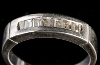 Lot 946 - A diamond ring, set baguette cut diamonds in...