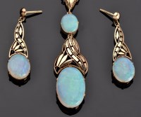 Lot 950 - An opal and yellow metal drop pendant and...