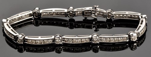 Lot 952 - A diamond bracelet, each of the nine...