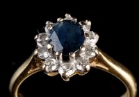 Lot 954 - A sapphire and diamond cluster ring, the oval...