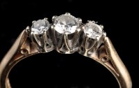 Lot 962 - A three stone diamond ring, the graduated...