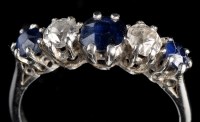 Lot 965 - A sapphire and diamond ring, the three...