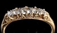 Lot 967 - A five stone diamond ring, the graduated...