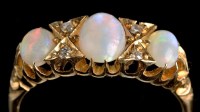 Lot 968 - An opal and diamond ring, the graduated oval...