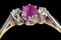 Lot 970 - A ruby and diamond ring, the oval facet cut...