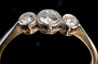 Lot 971 - A three stone diamond ring, the graduated...