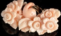 Lot 980 - A carved coral and yellow metal brooch,...