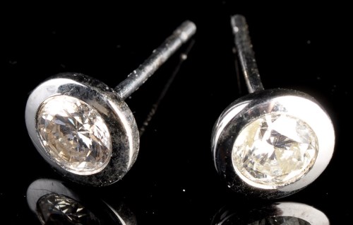 Lot 1001 - A pair of diamond stud earrings, each set...