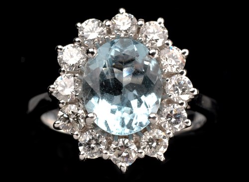 Lot 1002 - An aquamarine and diamond ring, the oval facet...
