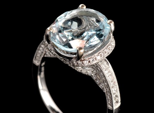 Lot 1003 - An aquamarine and diamond dress ring, the oval...