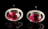 Lot 1004 - A pair of ruby and diamond cluster stud...
