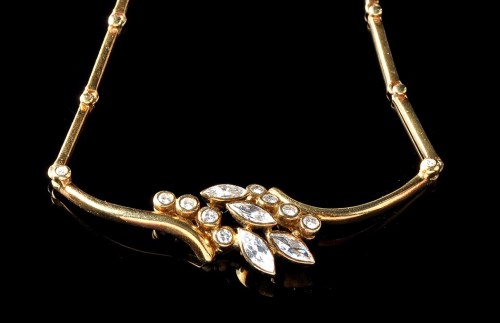 Lot 1010 - A diamond and 18ct. yellow gold necklace, set...