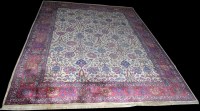 Lot 1015 - A Tabriz carpet, the ivory ground decorated...