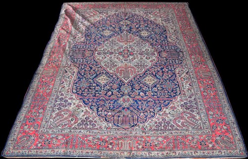 Lot 1018 - A West Persian carpet, the shaped oval central...