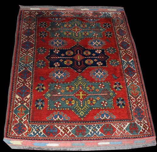 Lot 1022 - A Caucasian rug, with three shaped medallions...