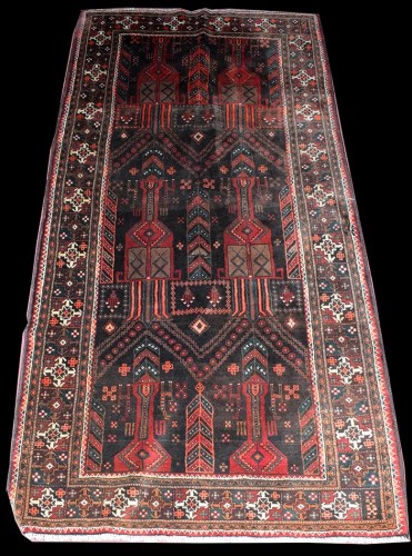 Lot 1024 - A Balouch rug, decorated with arches, deer and...