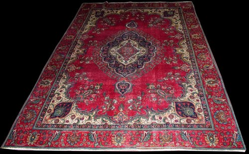 Lot 1027 - A Tabriz carpet, the central floral medallion...