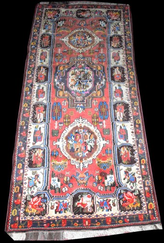 Lot 1028 - An Iranian village rug, with shaped medallion...