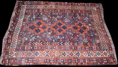 Lot 1041 - A Shiraz rug, with triple medallion to field...