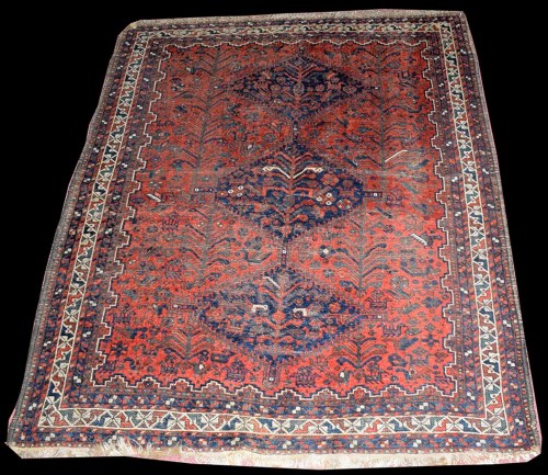 Lot 1044 - A Shiraz rug, the three medallions and ground...