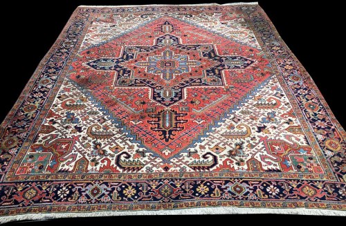 Lot 1062 - A Heriz carpet, with bold geometric floral...