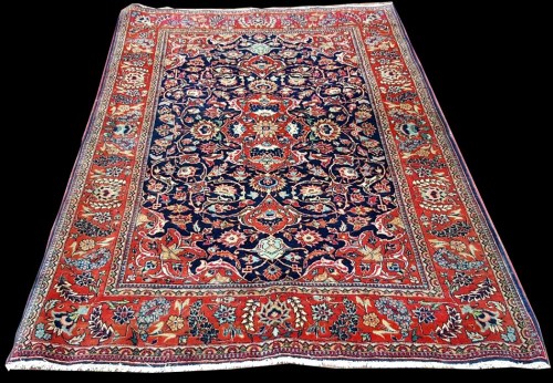 Lot 1063 - A Kashan rug, with bold floral scrolls around...