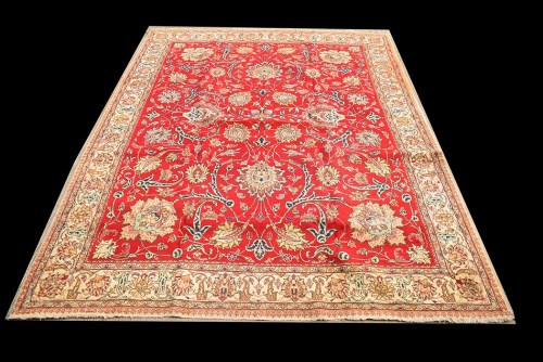 Lot 1079 - A Tabriz carpet, the red ground with bold...
