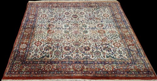 Lot 1097 - A Kashan rug, with floral scrolls on an ivory...