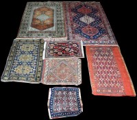 Lot 1107 - Seven small rugs, to include: an antique...
