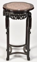 Lot 1145 - A Chinese carved hardwood jardiniere stand,...