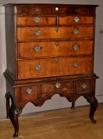 Lot 1165 - A Georgian walnut chest on stand, the flared...