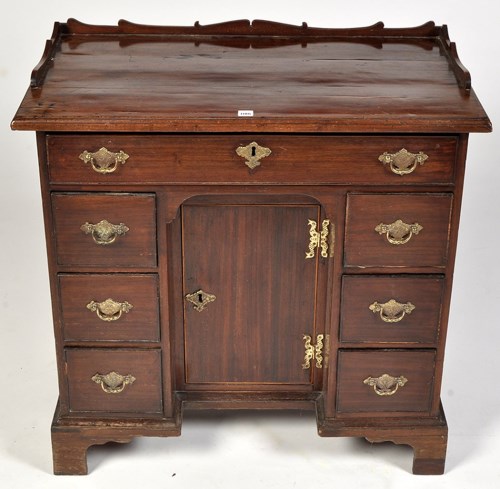 Lot 1186 - A George III mahogany kneehole desk, the...