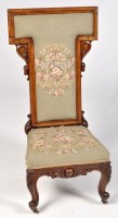 Lot 1217 - A Victorian carved walnut prie dieu, the back...