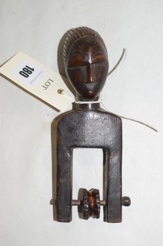 Lot 180 - A West African guro carved wooden pulley with...