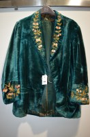 Lot 208 - A c.1920's green velvet smoking jacket with...