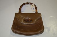 Lot 260 - A Gucci brown leather handbag, with whangee...
