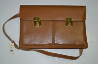Lot 261 - A tan leather document case with brass clasps.