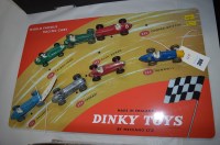Lot 304 - Seven Dinky Toys diecast racing cars on a...