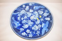 Lot 774 - A large ceramic wall plate with underglazed...