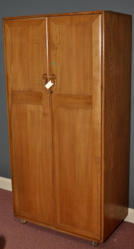 Lot 962 - Ercol: an elm Windsor style two-door wardrobe,...