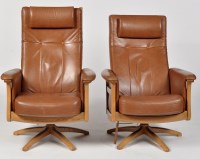Lot 967 - Ercol: two Gina swivel armchairs upholstered...