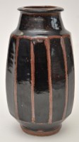 Lot 1076 - A Studio pottery vase and lidded pot, black...