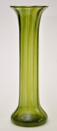 Lot 1086 - An elongated green glass vase, with flared rim,...