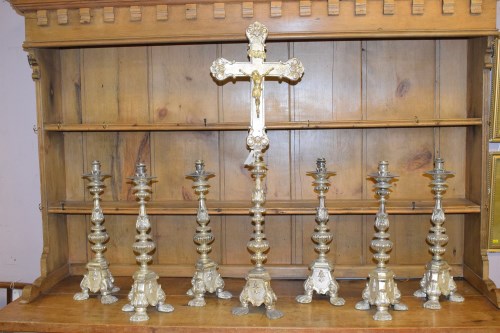 Lot 427 - A set of seven ecclesiastical candlesticks...