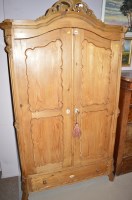 Lot 592 - A French armoire style stripped pine wardrobe,...