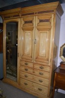 Lot 699 - An early 20th Century ash wardrobe, the mirror...