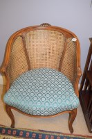 Lot 781 - A reproduction stained beech bergere chair,...